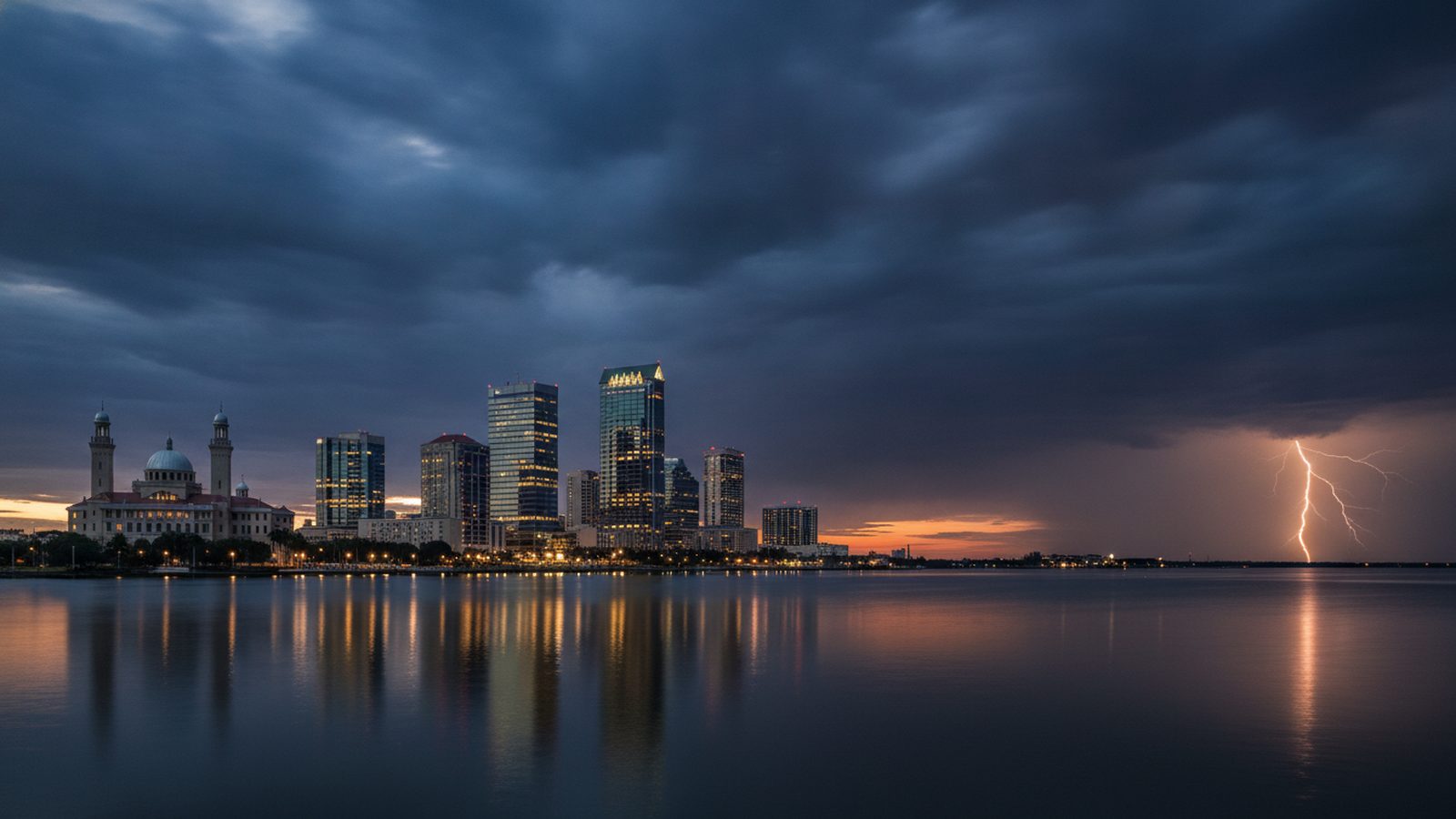 The downtown Tampa skyline at stormy dusk, seen across Hillsborough Bay